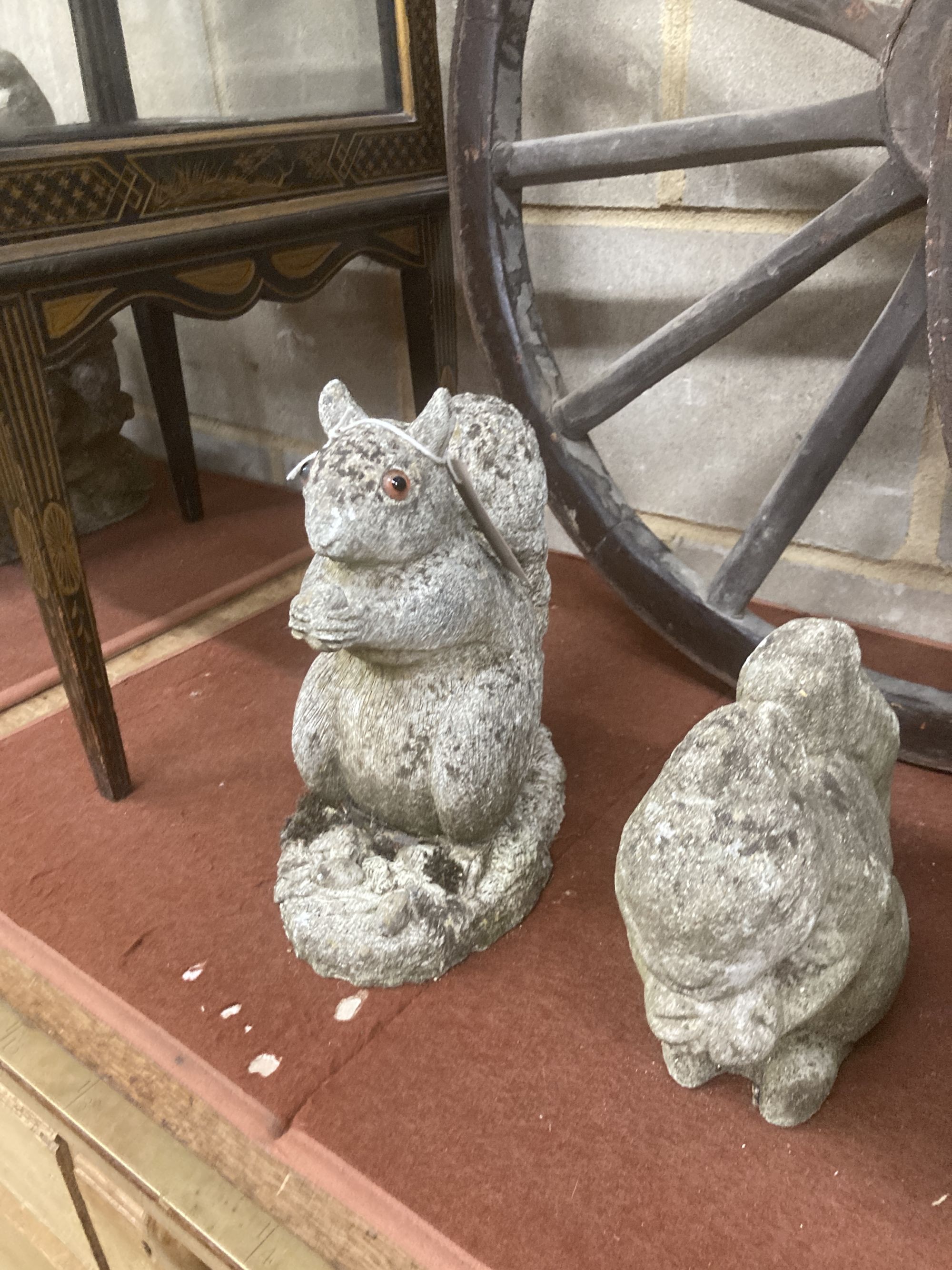 Four reconstituted stone squirrel garden ornaments, largest 26cm high
